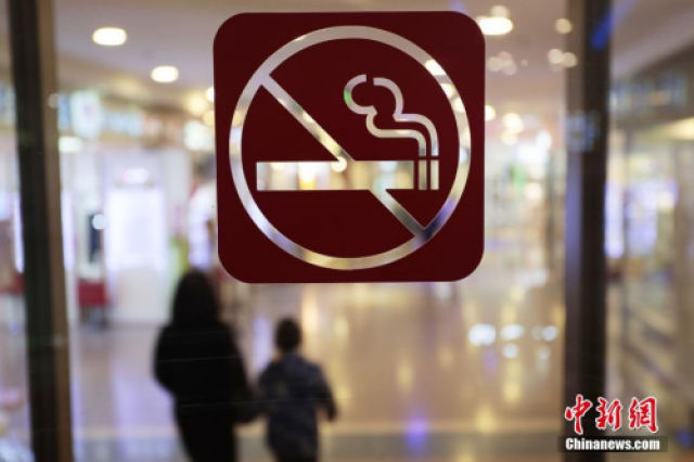 ↑资料图：上海某商场的醒目位置张贴了禁烟标识。中新社记者 张亨伟 摄