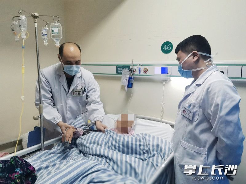 患者出院前，文戴华主任（左）为其进行身体相关检查。长沙晚报全媒体记者 杨蔚然 通讯员 何穰 程学荣 摄影报道