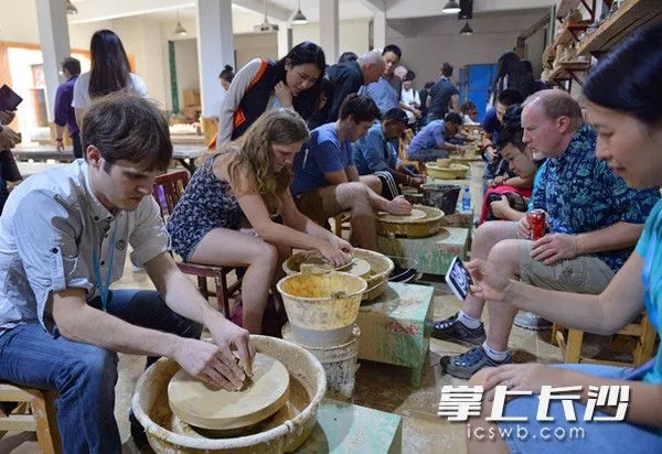 铜官古街陶瓷体验坊里，众多外国友人动手体验陶瓷的魅力。