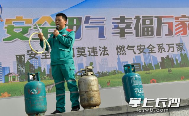 百江燃气工作人员正在给市民讲解如何正确辨别瓶装燃气配件的真假和安全性。