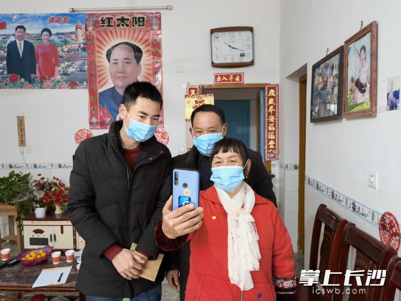 志愿者在志民村村民家，帮助刘如意与家中母亲“云团年”。均为高坪镇政府供图