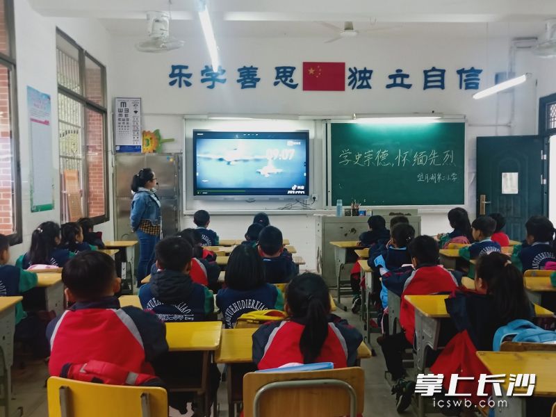 孩子们在观看讲述海空烈士王伟的纪录片。