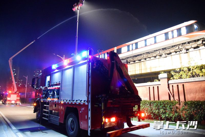 现场，消防车出水“灭火”，并进行照明方便救援。