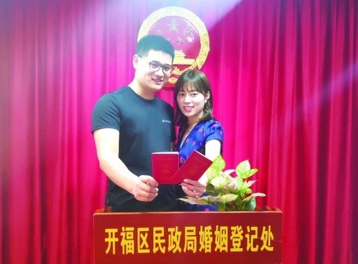 新人幸福地领取结婚证。记者石芳宇摄