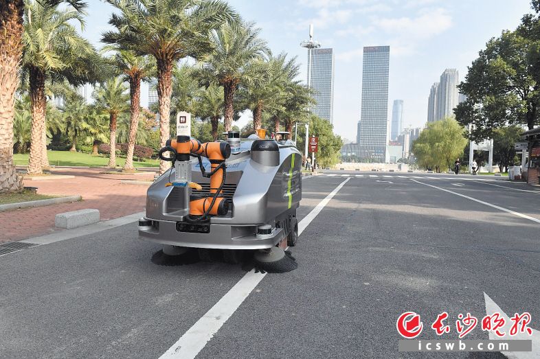 橘子洲景区配备的无人自动清扫车在规划路线内可以清扫路面垃圾，抓取道路上的塑料瓶，并精准地投入车内。 长沙晚报全媒体记者 余劭劼 摄