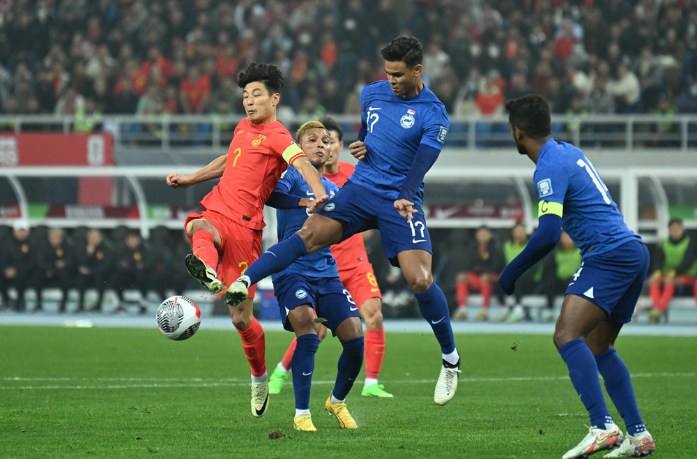 3月26日，中国队球员武磊（左一）面对新加坡队球员伊尔凡·凡迪（右二）的防守射门。新华社记者 孙凡越 摄